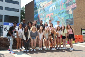 Leadership Knoxville Scholar students during Immersion Weekend in front of a mural downtown.