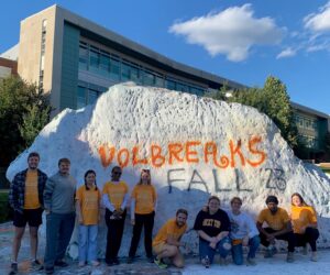 VOLbreaks students posing in front of The Rock, painted with "VOLbreaks Fall '23"